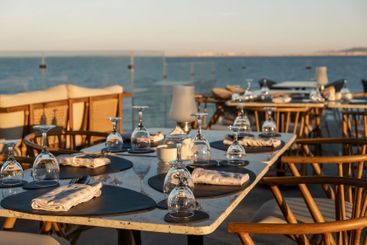 Beautifully arranged tables at a seaside restaurant with...
