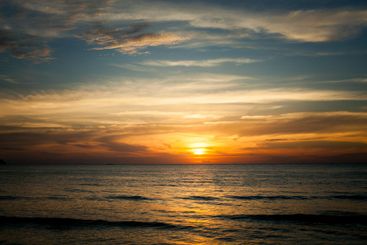 A tropical seaside beach during a stunning sunset