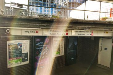 Urban train station entrance illuminated by sunlight...