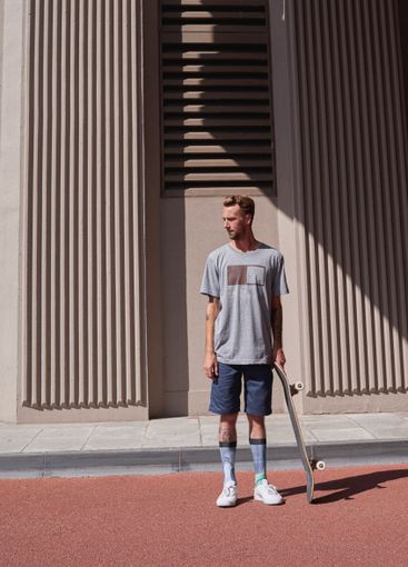 Skateboard, streetwear and urban with man in city for...