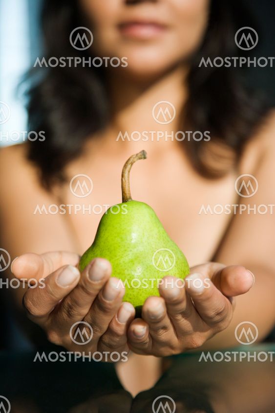 Woman holding pear.