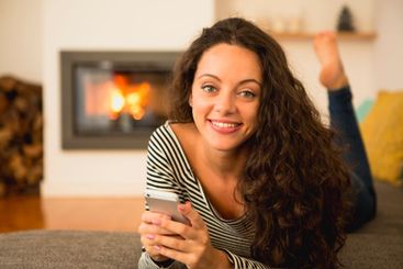 Woman with her cellphone at home