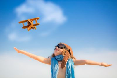 Happy kid playing with toy airplane