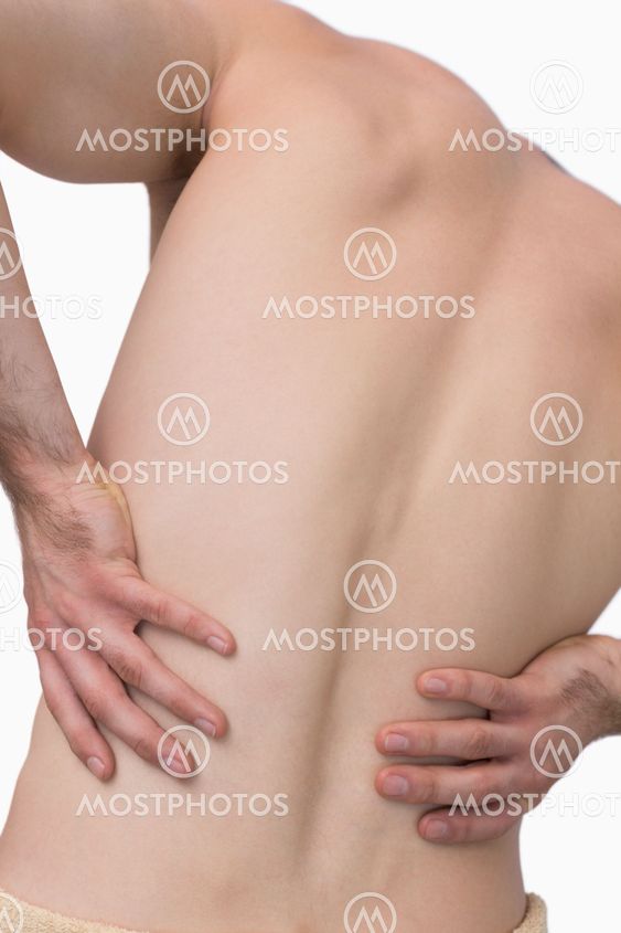 Rear view of shirtless man with back pain