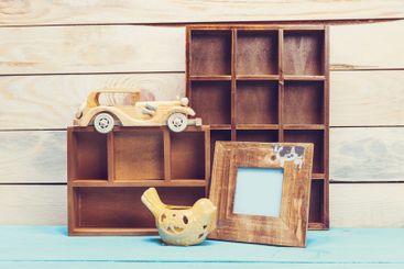 Cozy pastel wooden home decor objects on blue background