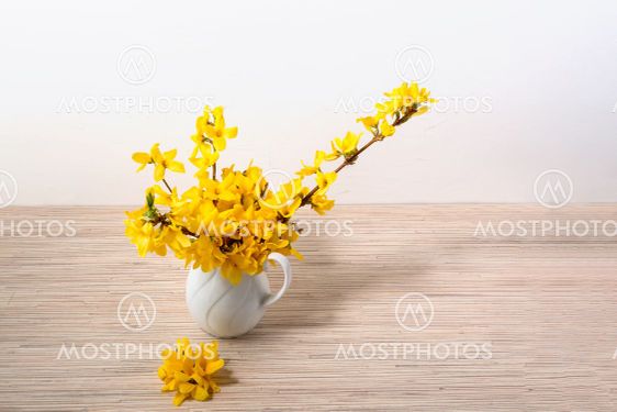 Yellow flower bouquet in vase on table with copy space