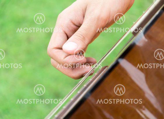 hand playing on guitar