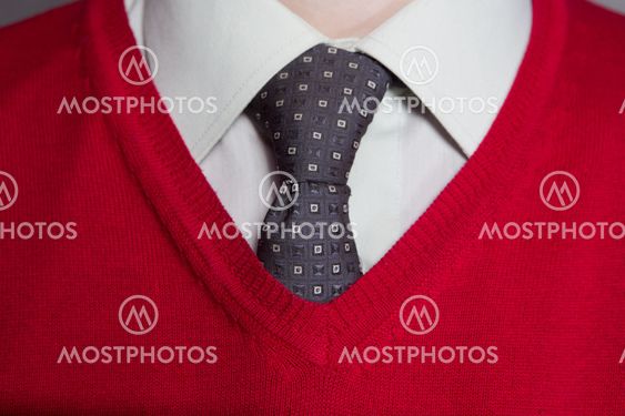Man wearing white shirt, red sweater and necktie