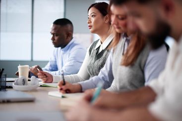 Studying In Classroom At Campus. Students Writing