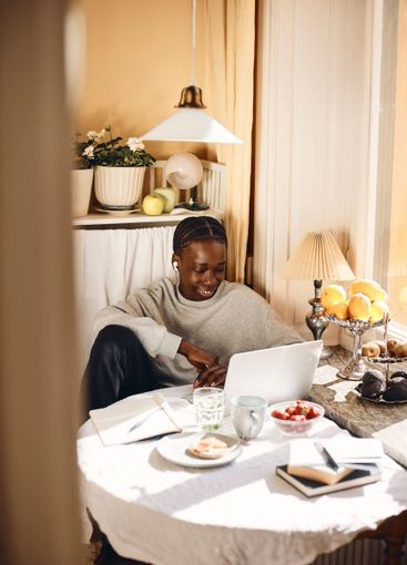 High angle view of teenage boy watching laptop while...