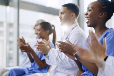 Medical team, happy and applause for celebration with...