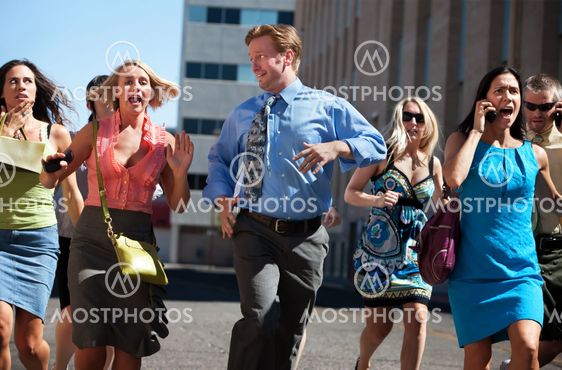Young business workers run down steet.