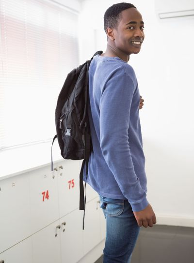 Smiling university student with backpack 