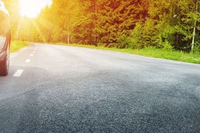 Car on asphalt road in summer