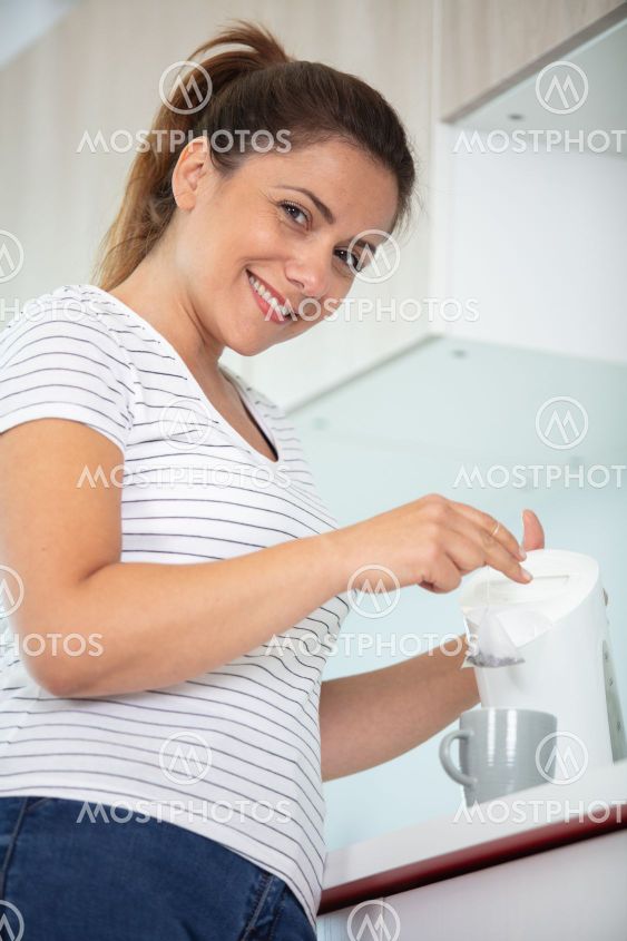 woman making a cup of tea at home
