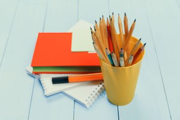 Stationery collection with colored pencils, notebooks,...