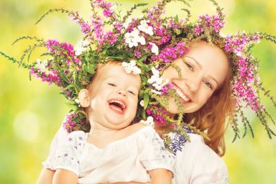 happy laughing daughter hugging mother in wreaths of...