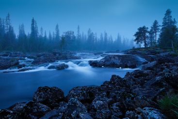 Waterfall in river at sunset
