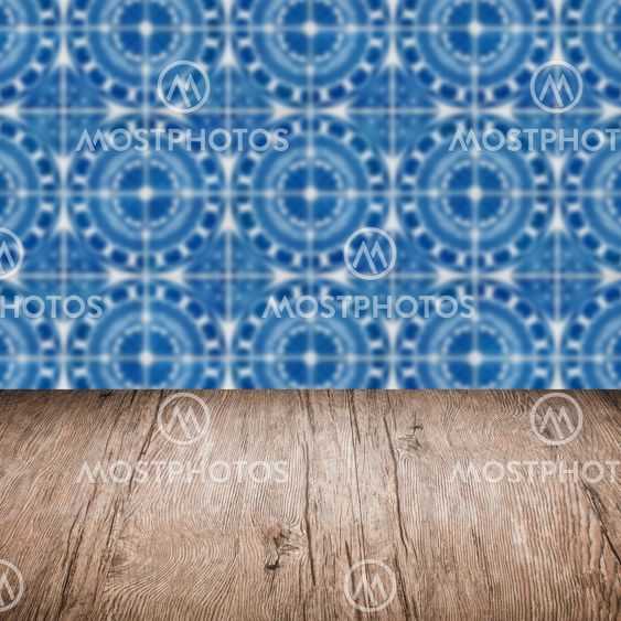 Wood table top and blur vintage ceramic tile pattern wall