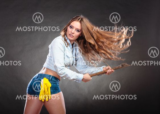 Sexy strong woman feminist with axe working.