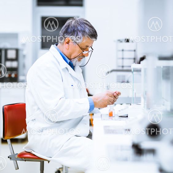 Senior male researcher carrying out scientific research in a lab (shallow DOF; color toned image)