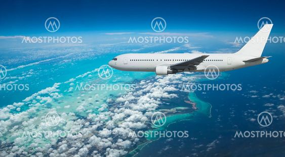 Airliner over exotic island