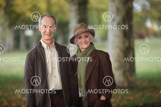 old couple in a park at autumn season