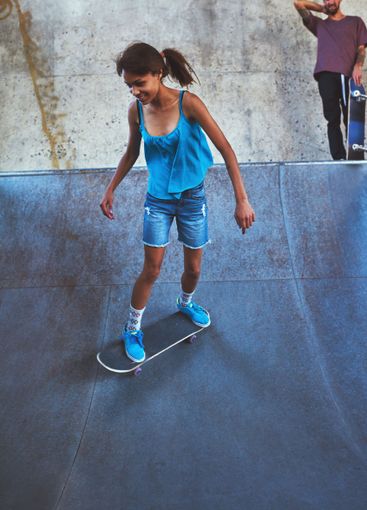 Skateboard, city and girl on ramp for skating stunt,...