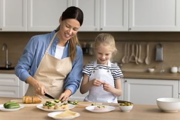 Preschooler daughter helping out with meal preparation...