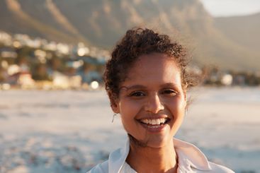 Portrait, relax and woman on beach in summer for travel,...