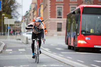 Courier Delivery Man Using Walkie-Talkie While Riding...