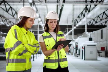 Female Engineer Conducts OSHA Inspection Using Tablet