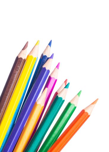 Bright assortment of colored pencils arranged in a...