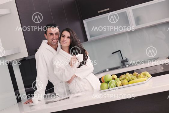 young couple have fun in modern kitchen