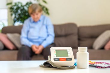 An old woman measures her blood pressure. Selective focus.