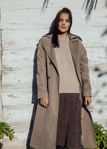 Beautiful fashionable brunette woman in gray autumn coat