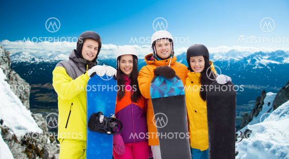 happy friends in helmets with snowboards outdoors