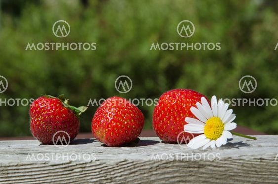 Fresh strawberries at green background