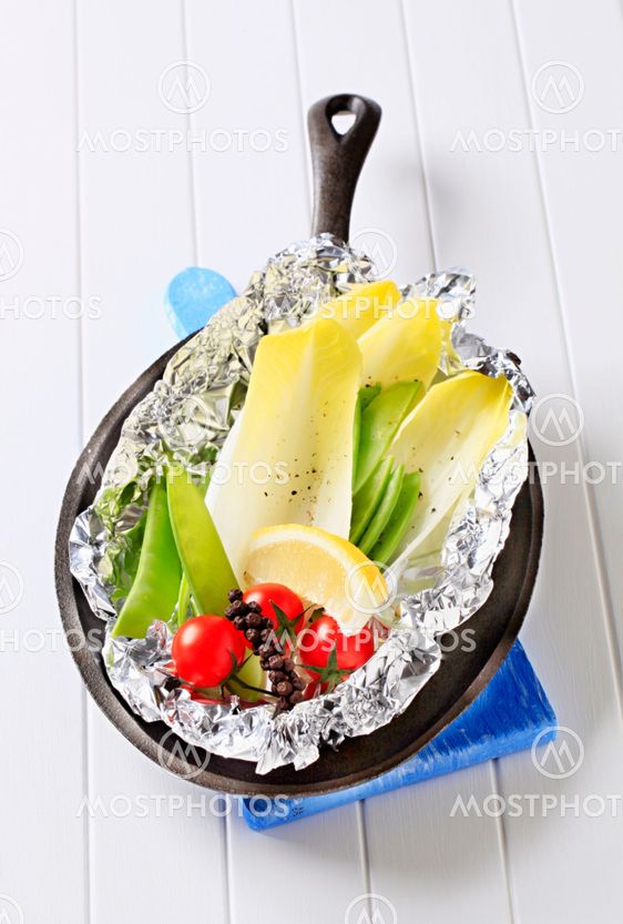 Fresh vegetables on tinfoil in skillet