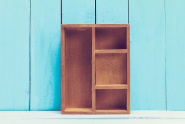 Cozy pastel wooden home decor objects on blue background