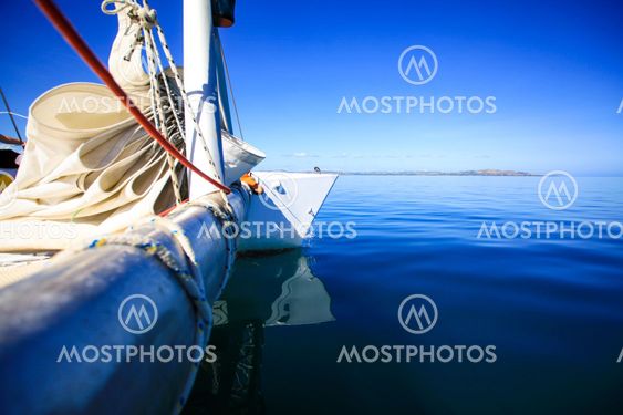 Bow of a sailing boat in calm blue sea