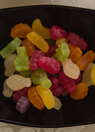 Close-up of coloured jelly beans in a black bowl