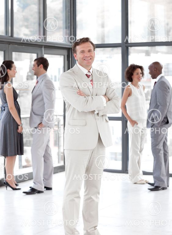 portrait of a smiling male manager leading his team