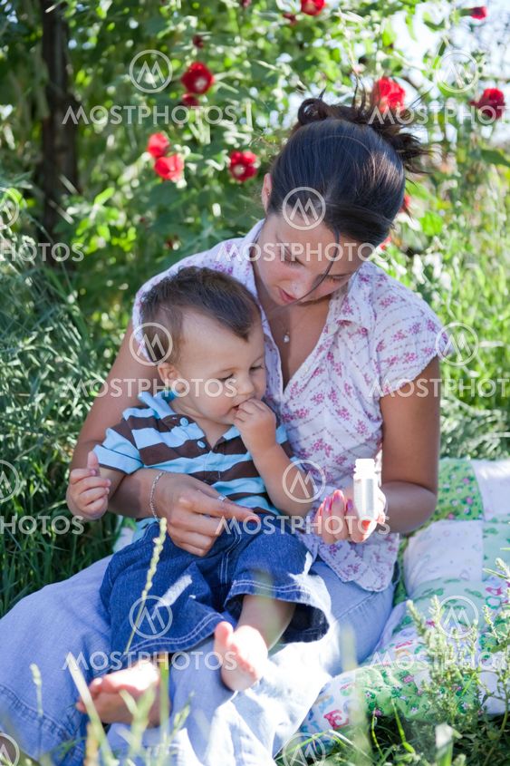 Mother giving homeoptahic medicine to her son