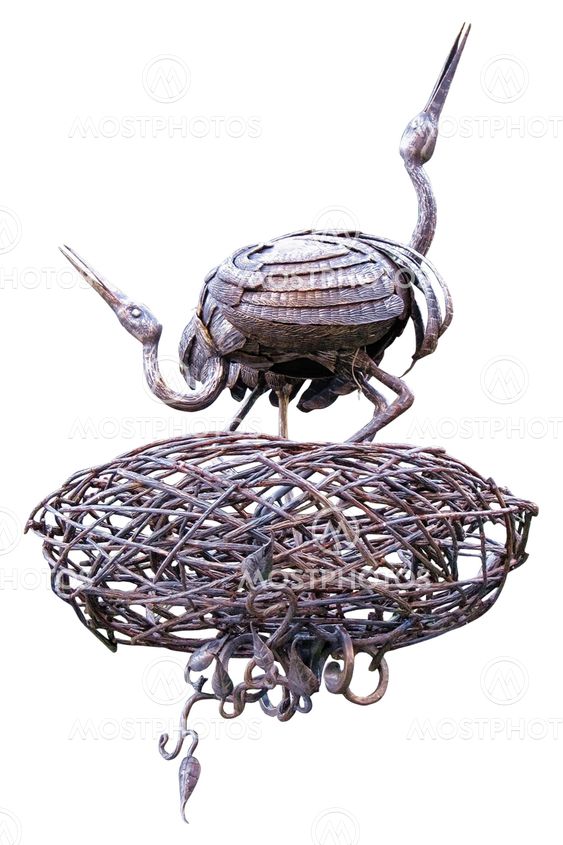 Stork couple forged figures in nest