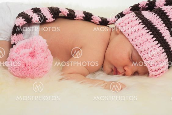 infant sleeping in the white sheep's clothing.