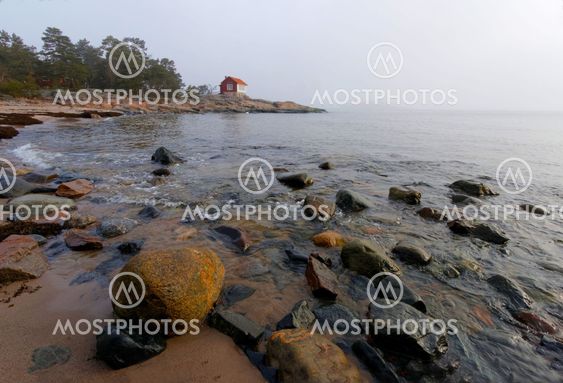 Coast line and small red cottage