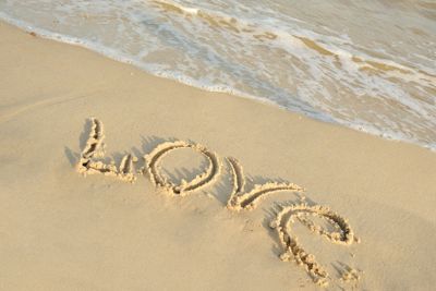 Inscription "love" on sand