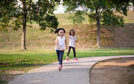 Asian Little Chinese Sisters running happily