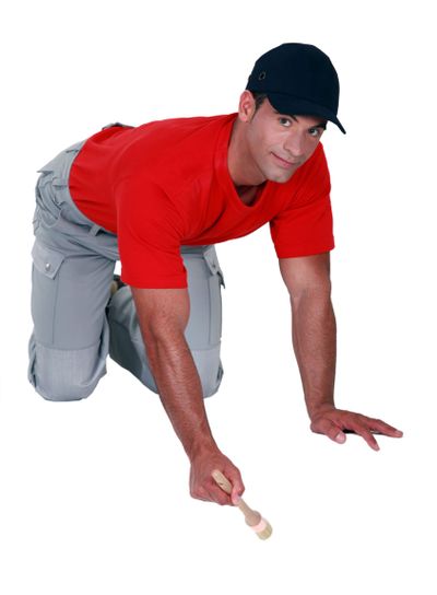 A painter working on the floor.